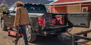 How to Attach Tow Hitch - Image of a man walking away from a trailer attached to a 2025 Ford F-150