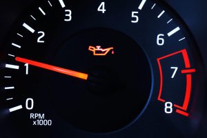 Why Is My Oil Light On? Image of oil light illuminated on vehicle dashboard