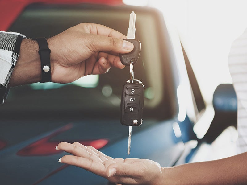 Atchinson Ford in Belleville MI customer handing over keys to a new car